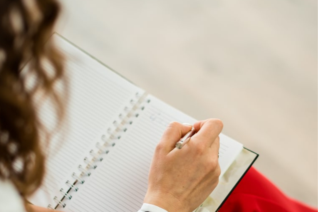 lady writing in notebook